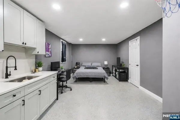 a view of a kitchen with sink a living room and utility room