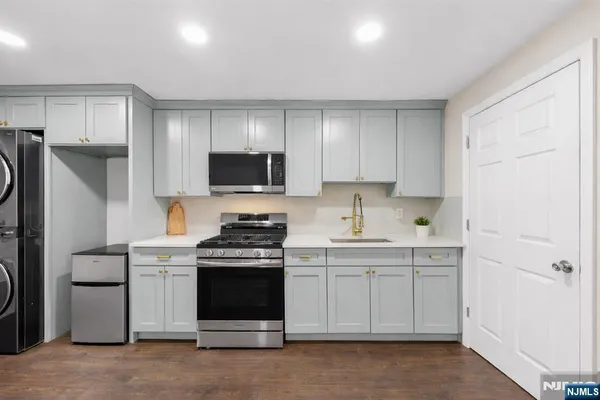 a kitchen with a sink appliances and cabinets
