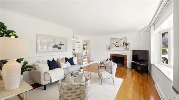 a living room with furniture a flat screen tv and a fireplace