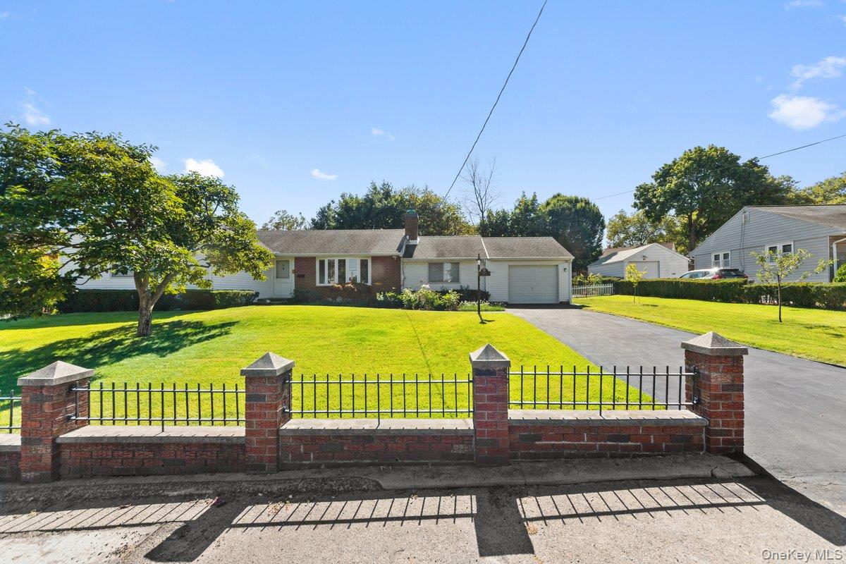 247 Croydon Road Yonkers, NY 10710 - Photo 2 of 27 View of front of property with driveway, a fenced front yard, and a garage