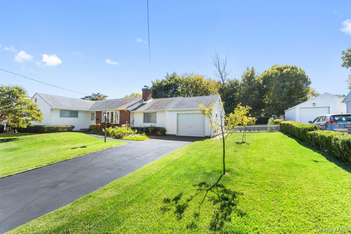 247 Croydon Road Yonkers, NY 10710 - Photo 3 of 27 Ranch-style house featuring a chimney, asphalt driveway, and an attached garage