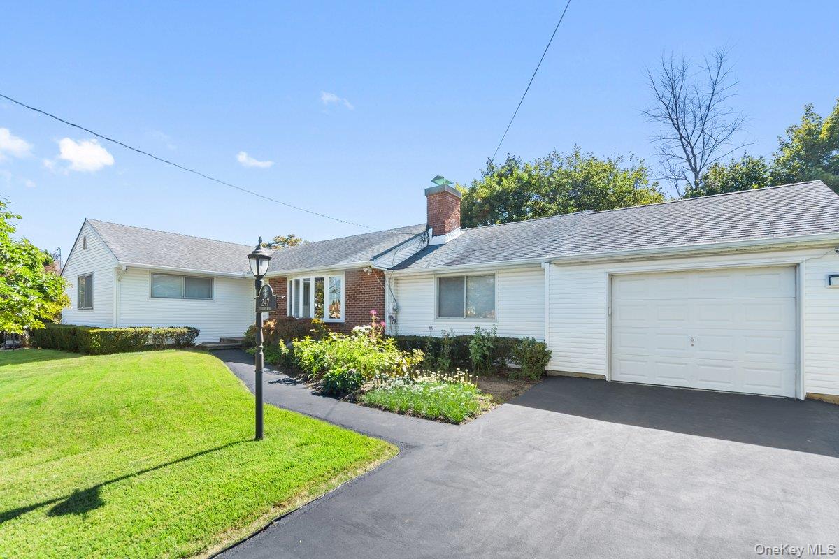 247 Croydon Road Yonkers, NY 10710 - Photo 4 of 27 Ranch-style house with a front yard, asphalt driveway, an attached garage, a chimney, and a shingled roof