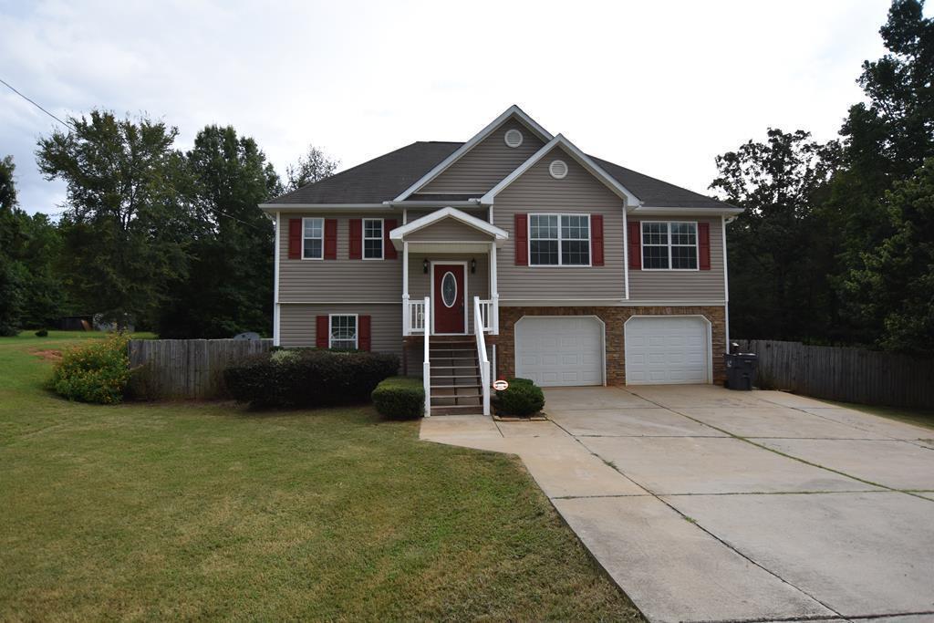3315 Trotter''s Ridge Trail Gray, GA 31032 - Photo 1 of 26 a front view of a house with a yard and garage