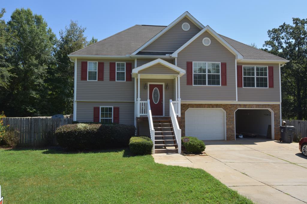 3315 Trotter''s Ridge Trail Gray, GA 31032 - Photo 2 of 26 a front view of a house with a yard and garage