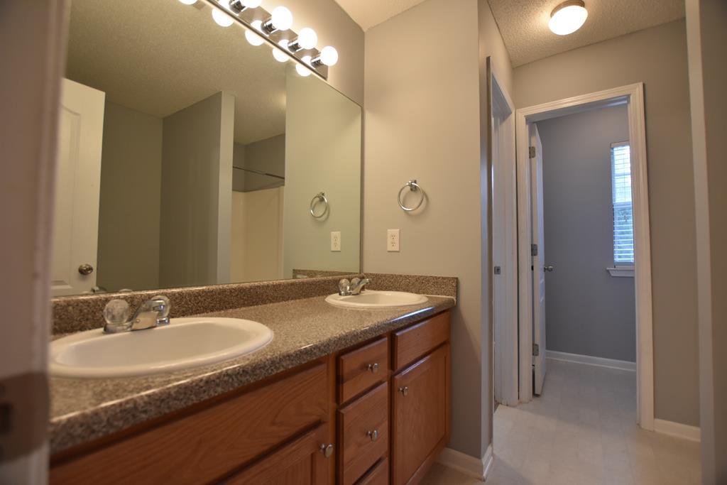 3315 Trotter''s Ridge Trail Gray, GA 31032 - Photo 12 of 26 a bathroom with a granite countertop sink a large mirror and a shower