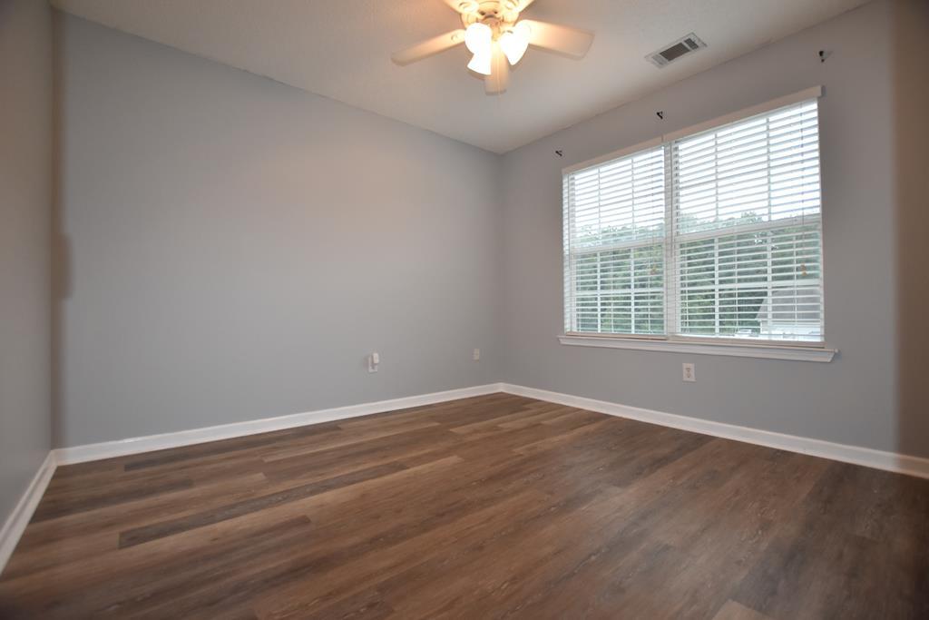 3315 Trotter''s Ridge Trail Gray, GA 31032 - Photo 16 of 26 a view of an empty room with wooden floor and a window