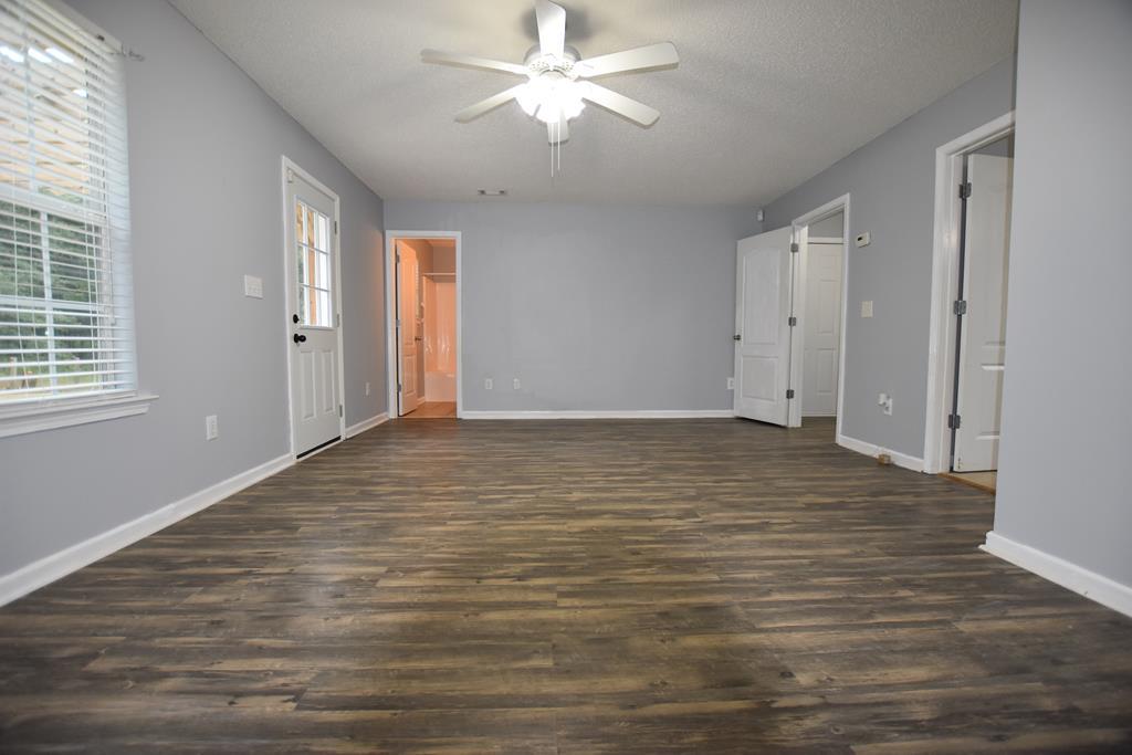 3315 Trotter''s Ridge Trail Gray, GA 31032 - Photo 18 of 26 a view of an empty room with wooden floor and a window