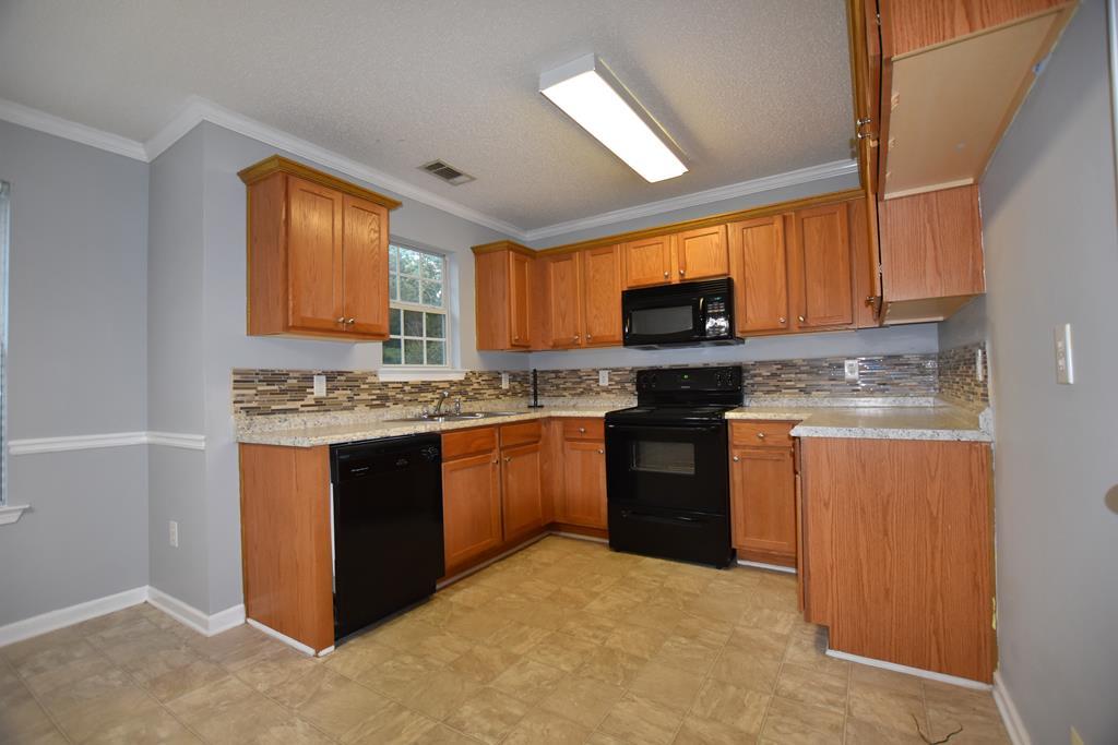 3315 Trotter''s Ridge Trail Gray, GA 31032 - Photo 5 of 26 a kitchen with stainless steel appliances granite countertop a stove a sink dishwasher and a microwave oven with cabinets