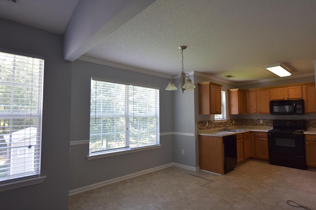 3315 Trotter''s Ridge Trail Gray, GA 31032 - Photo 8 of 26 a kitchen with stainless steel appliances granite countertop a sink and a stove