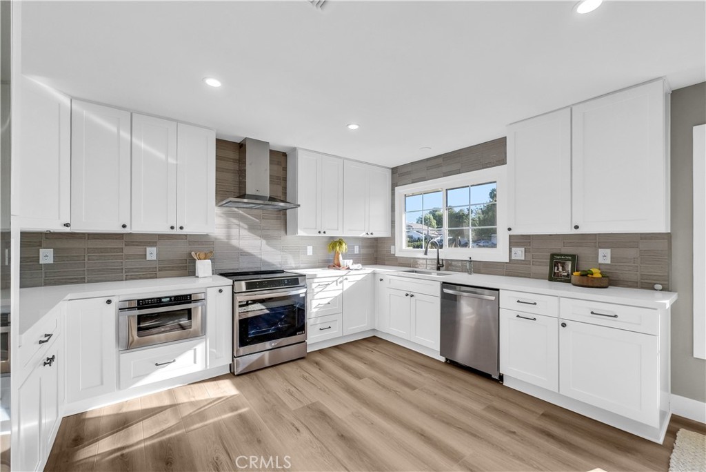 273 St Crispen Avenue Brea, CA 92821 - Photo 5 of 28 a kitchen with granite countertop white cabinets and stainless steel appliances