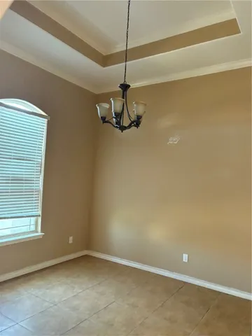 a view of a room with a ceiling fan and window