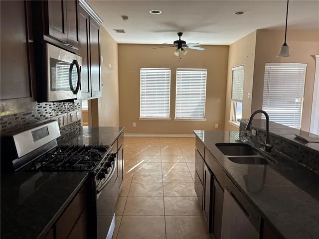 a kitchen with a sink stove and microwave