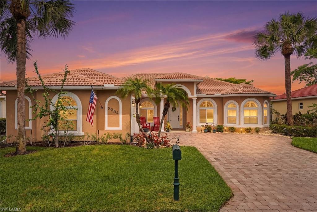 Single home , one story,stucco siding, a tile roof, and a front lawn