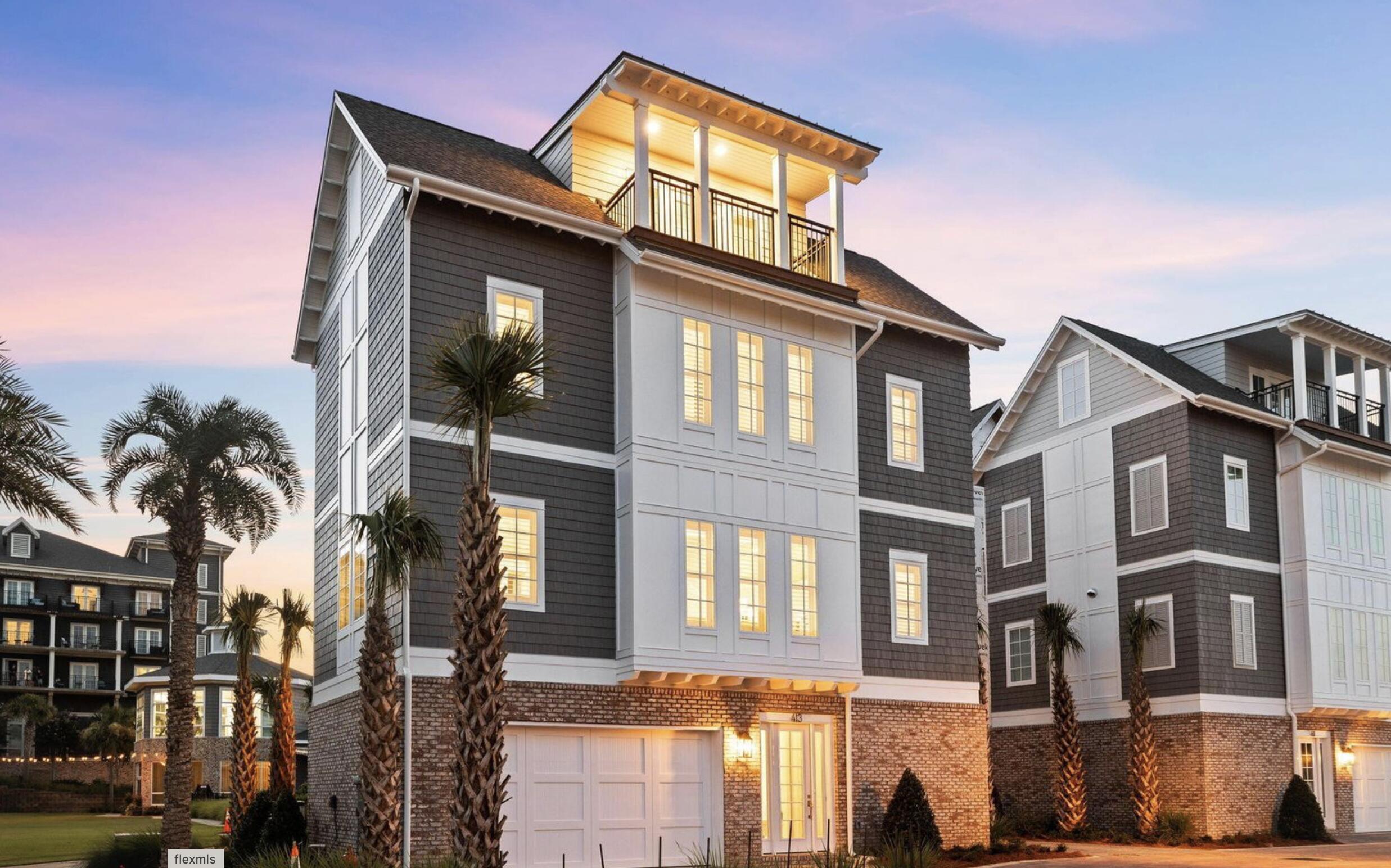 413 Henderson Cottage Way Destin, FL 32541 - Photo 1 of 70 a front view of a residential apartment building with a yard