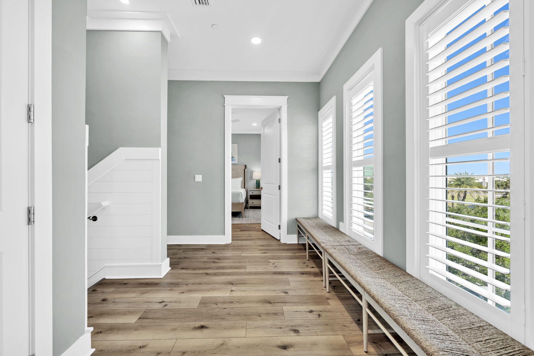 413 Henderson Cottage Way Destin, FL 32541 - Photo 16 of 70 a view of a hallway with wooden floor and staircase