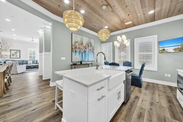 a view of a livingroom with wooden floor and a refrigerator
