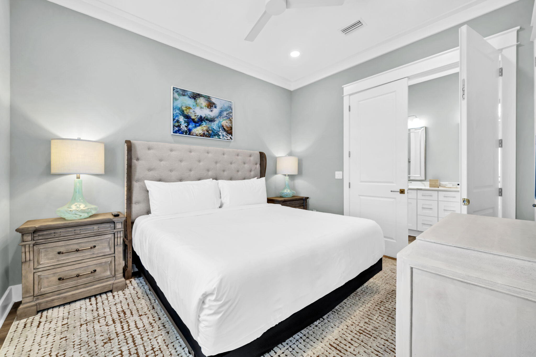 413 Henderson Cottage Way Destin, FL 32541 - Photo 17 of 70 a bedroom with a bed and a lamp on dresser