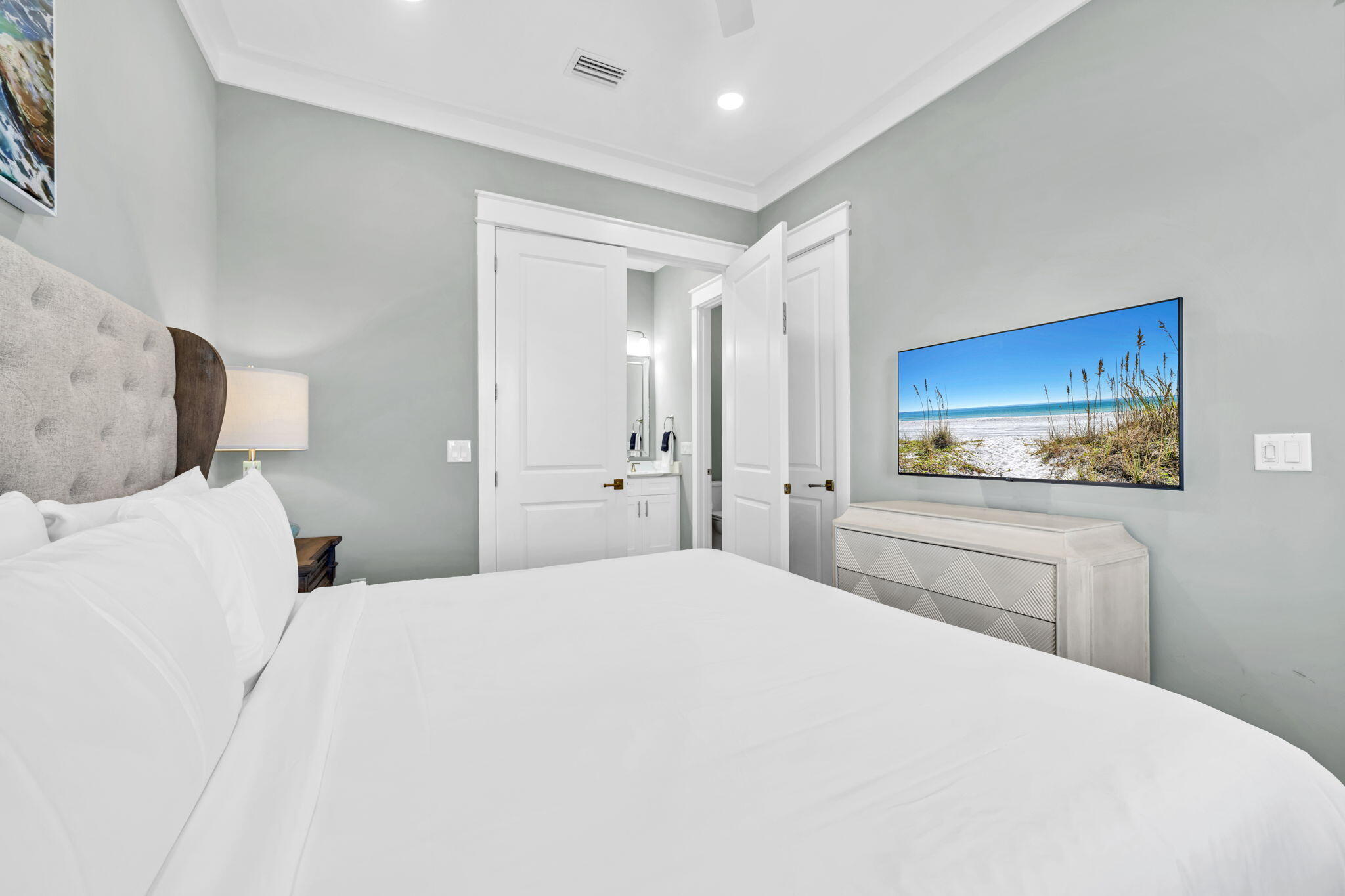 413 Henderson Cottage Way Destin, FL 32541 - Photo 18 of 70 a bedroom with a bed and a flat screen tv