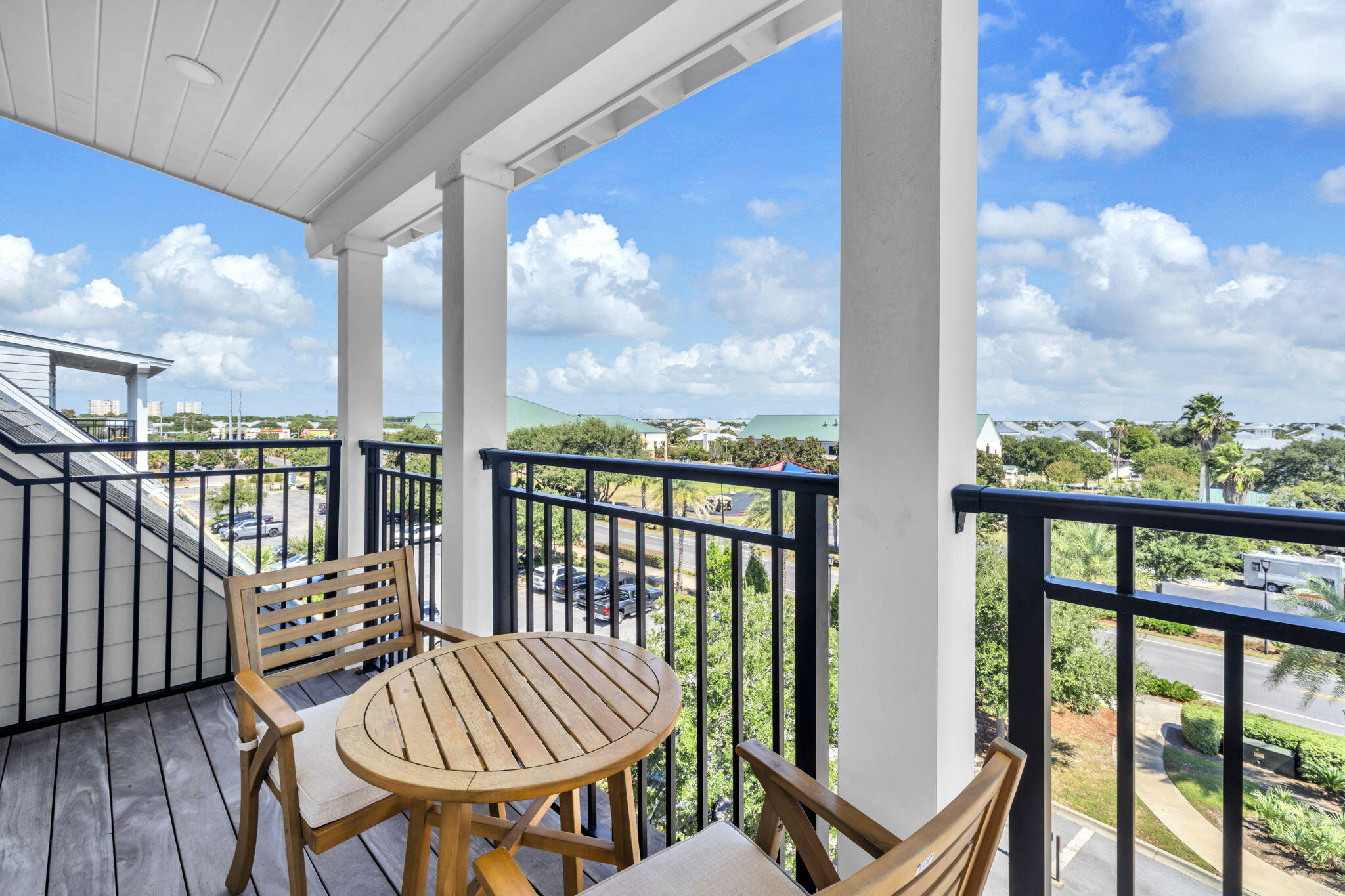 413 Henderson Cottage Way Destin, FL 32541 - Photo 30 of 70 a view of a balcony with chair and wooden floor