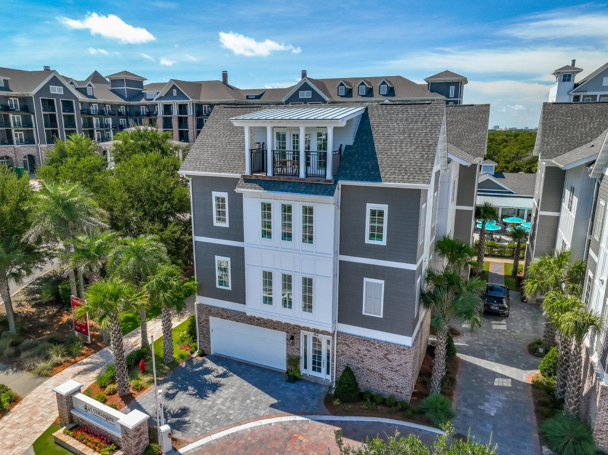 413 Henderson Cottage Way Destin, FL 32541 - Photo 70 of 70 a front view of a residential apartment building with a yard