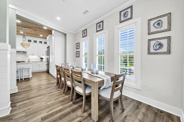 a kitchen with stainless steel appliances granite countertop a stove a sink dishwasher and a refrigerator with wooden floor