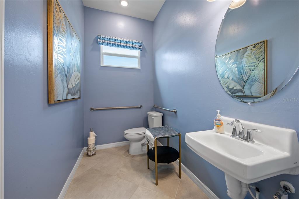 7161 Inlet Isles Lakewood Ranch, FL 34202 - Photo 13 of 29 a bathroom with a toilet a sink and mirror