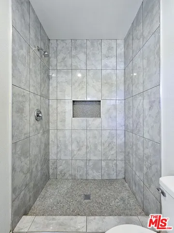 a view of an empty room and wooden floor