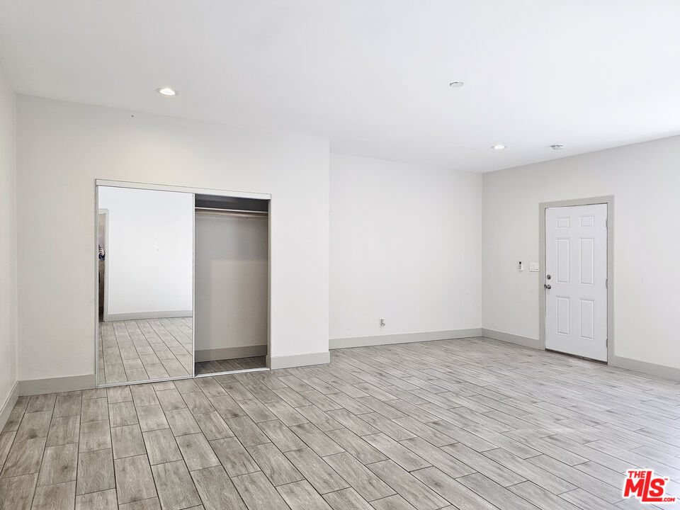 38580 Rancho Los Cerritos Drive, Unit S2 Indio, CA 92203 - Photo 13 of 44 a view of an empty room with wooden floor and closet
