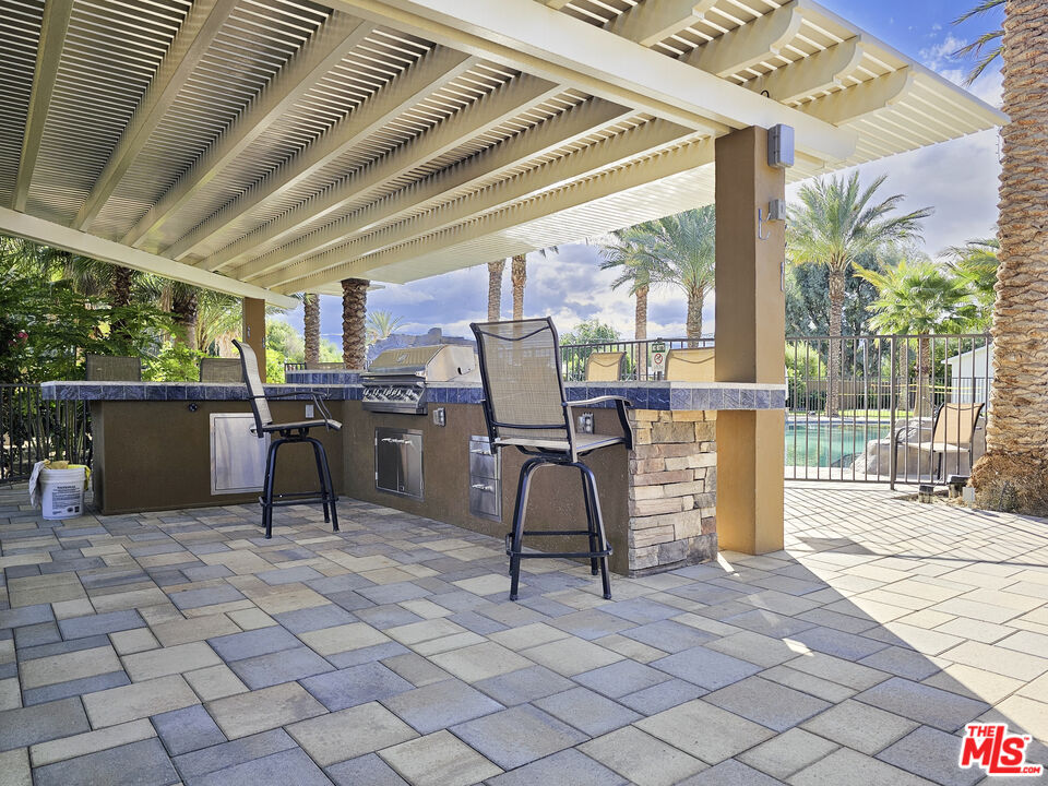 38580 Rancho Los Cerritos Drive, Unit S2 Indio, CA 92203 - Photo 17 of 44 a view of a patio with table and chairs