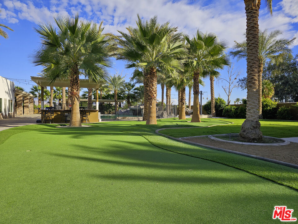 38580 Rancho Los Cerritos Drive, Unit S2 Indio, CA 92203 - Photo 21 of 44 a view of a palm trees in front of a house