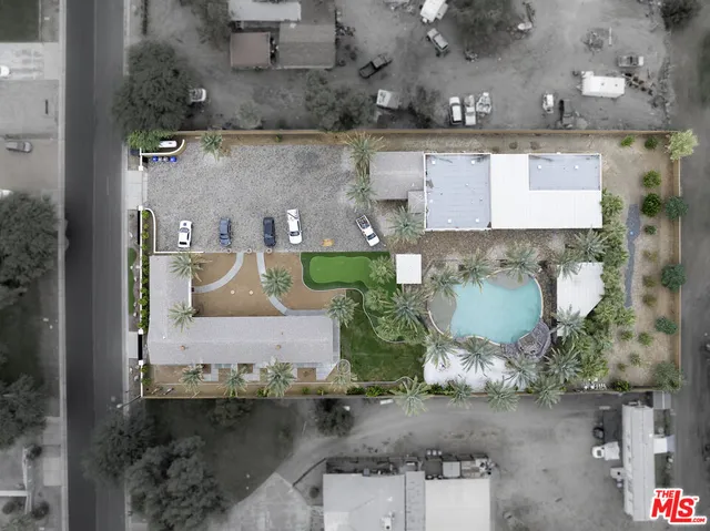 an aerial view of a house with a yard