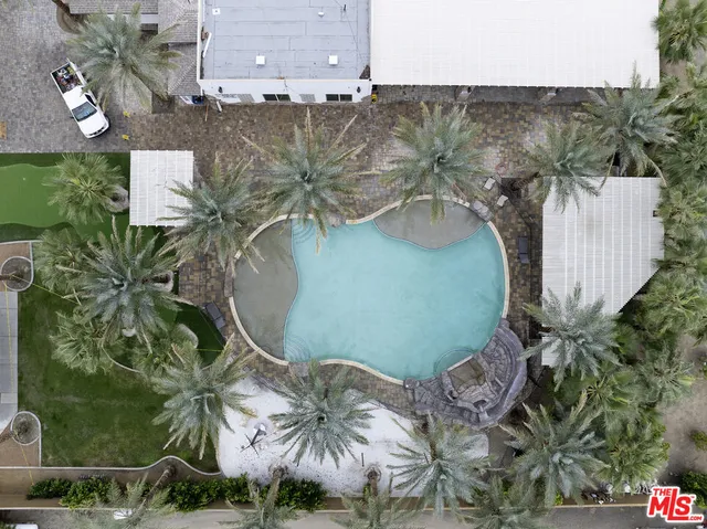 an aerial view of a house with a yard and lake view