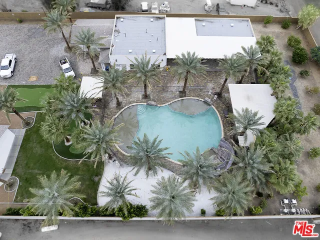 an aerial view of a house with garden space and swimming pool