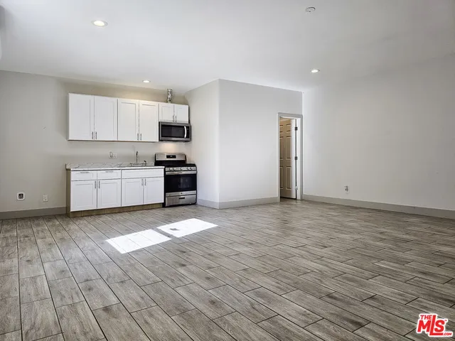 a kitchen with granite countertop a stove and a sink