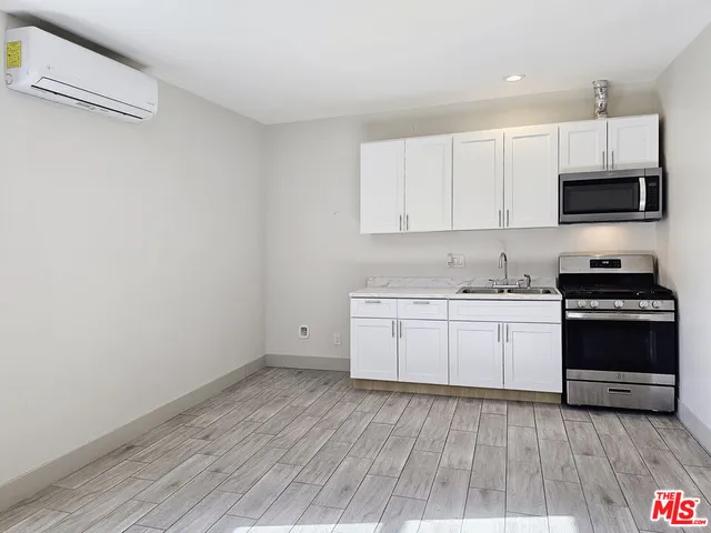 a view of a kitchen with electric appliances