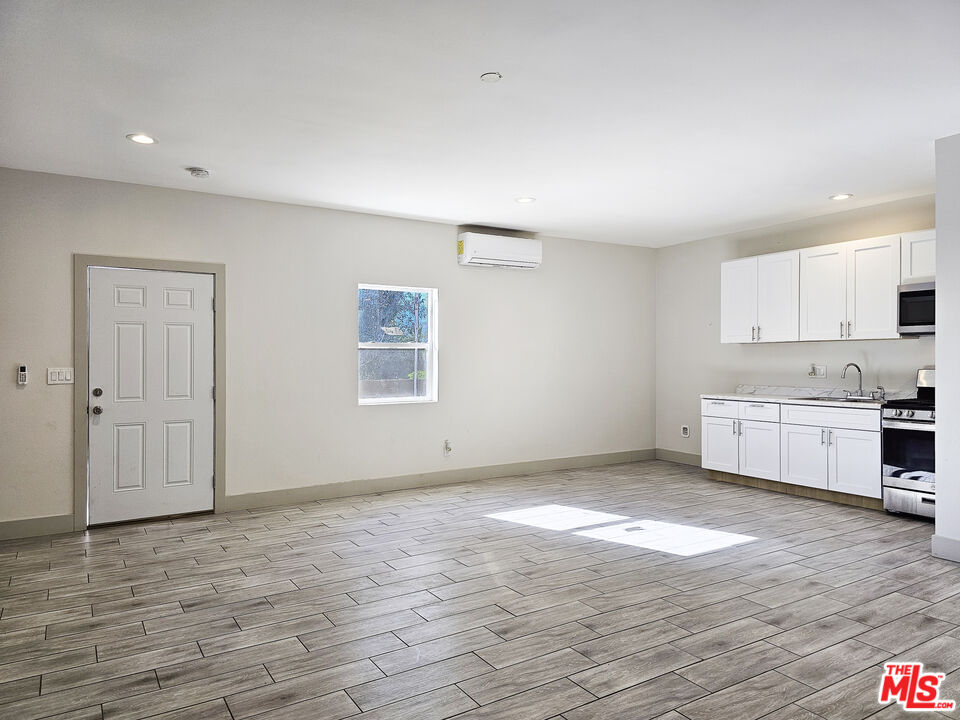 38580 Rancho Los Cerritos Drive, Unit S2 Indio, CA 92203 - Photo 7 of 44 a view of a kitchen with wooden floor and a sink