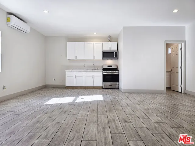 a kitchen with wooden floors and white appliances