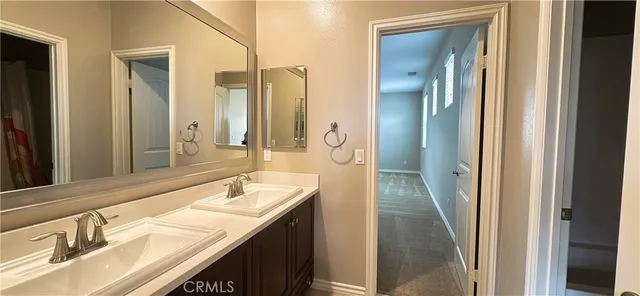 a bathroom with a sink double vanity and a mirror