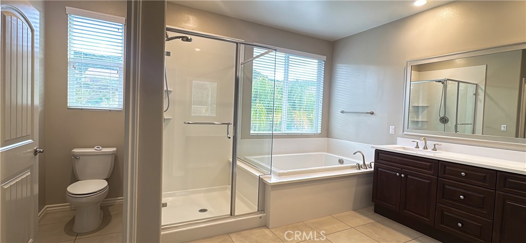 33833 Edge Temecula, CA 92592 - Photo 16 of 18 a bathroom with a bathtub toilet sink vanity and windows