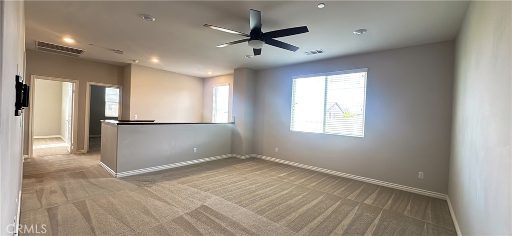 33833 Edge Temecula, CA 92592 - Photo 17 of 18 an empty room with wooden floor and a ceiling fan