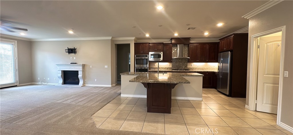 33833 Edge Temecula, CA 92592 - Photo 4 of 18 a kitchen with kitchen island granite countertop stainless steel appliances a counter top space and cabinets