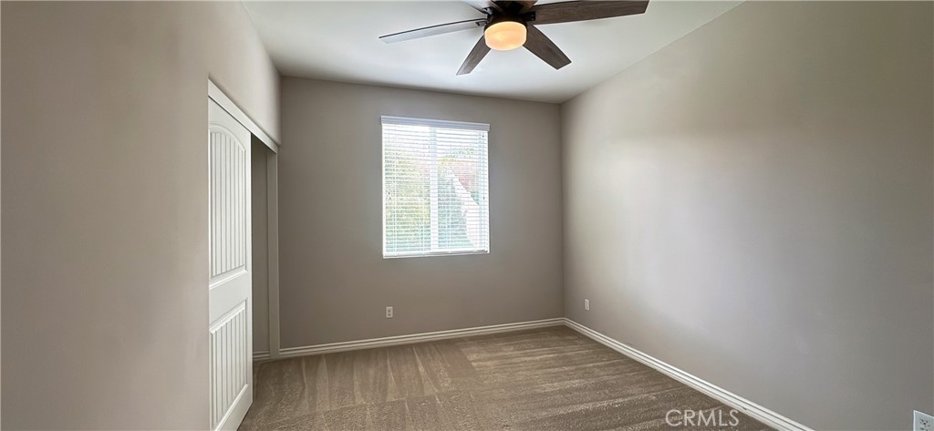 33833 Edge Temecula, CA 92592 - Photo 8 of 18 an empty room with a window and a fan