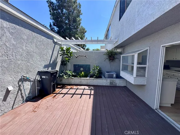 a view of a balcony with chairs and wooden floor