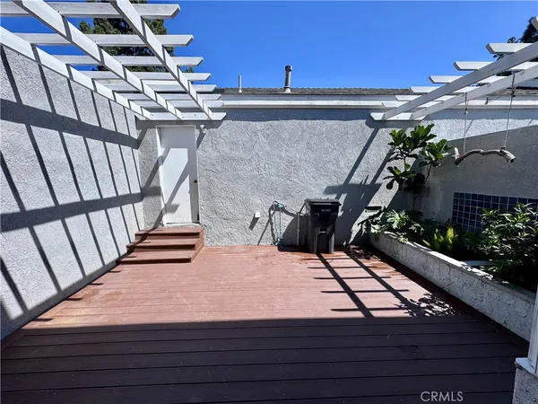 a view of a balcony with wooden floor