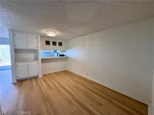 a kitchen with wooden floors and refrigerator
