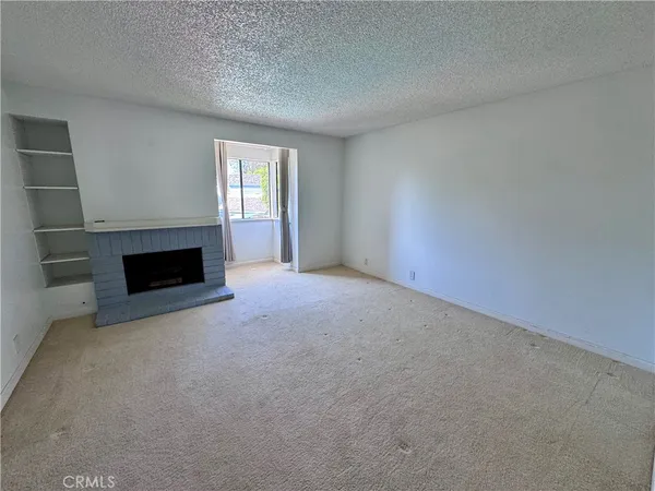 a view of empty room with a fireplace
