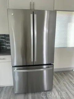 a view of a refrigerator with wooden floor
