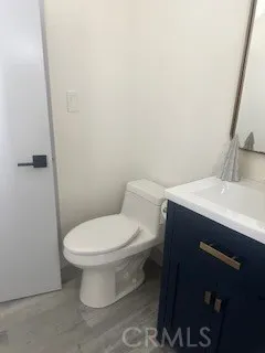 a bathroom with a sink toilet and a mirror
