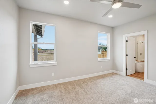 an empty room with closet and a chandelier fan
