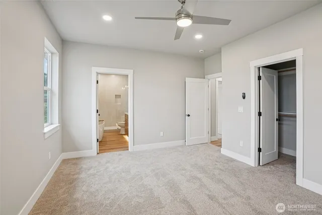an empty room with closet and windows